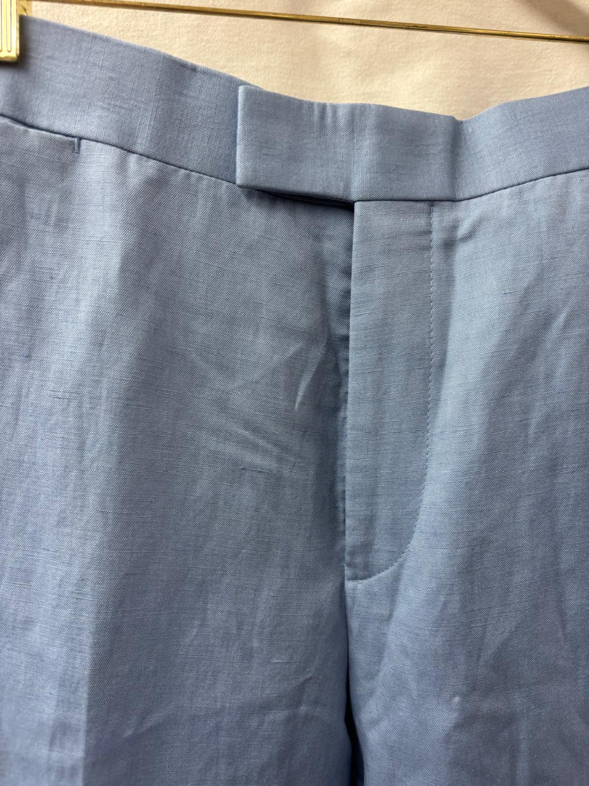 Close-up of gray pants with a focus on the waistband.